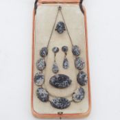 A 1930's suite of black & grey jadeite jewellery to include a graduated pierced & carved necklace,