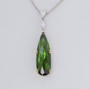 An 18ct yellow & white gold pendant set with an elongated mixed cut tear drop shaped green