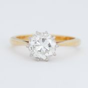 An 18ct yellow & white gold ten claw solitaire ring set with a round brilliant cut diamond,