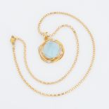 An 18ct yellow gold abstract style pendant set with a square cut cabochon blue topaz, measuring