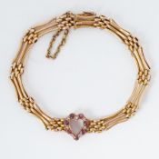 A 15ct yellow gold three bar gate bracelet with a cut-out ruby & diamond heart, circa 1920, total