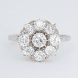 A platinum and 18ct yellow gold daisy style cluster ring set with old cut diamonds, total diamond