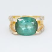 An unusual 18ct yellow gold cocktail style ring set with a central rectangular shaped green gemstone