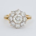 An 18ct yellow & white gold cluster ring set with old round brilliant cut diamonds, the central