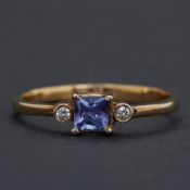 An 18ct yellow gold ring set with a princess cut tanzanite, approx.0.30 carats with a round