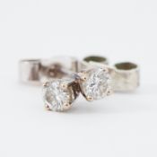 A pair of 9ct white gold diamond stud earrings, total diamond weight approx. 0.24 carats, with