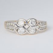 An 18ct yellow & white gold two row twist design ring set with round brilliant cut diamonds, total