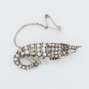 An Edwardian 'shrimp' design brooch set with old rough cut diamonds of varying shapes & sizes and
