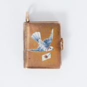 A gold locket in the shape of a book inset with a Dove & envelope set with a small ruby, measuring