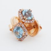 A pair of yellow gold earrings set with a central cushion cut aquamarine, total weight of aquamarine
