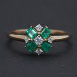 A 9ct yellow gold ring set with four baguette cut Colombian emeralds, total weight 0.46 carats