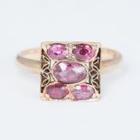 A 1930's rose gold square design cluster ring set with five oval cut rubies, approx. 1.30 carats, (