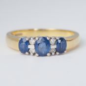 An 18ct yellow & white gold ring set with three oval cut sapphires, total weight approx. 0.65