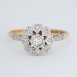 An 18ct yellow gold & platinum flower cluster ring with heart design petals set with an older