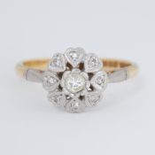 An 18ct yellow gold & platinum flower cluster ring with heart design petals set with an older