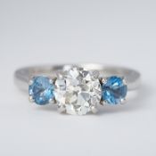 An impressive platinum three stone ring set with a central old European cut diamond, approx. 1.84