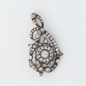 A Victorian 'scroll' design brooch set with old round cut diamonds, the largest diamond is approx.