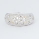 An 18ct white gold ring with a start design inset with a total of 0.35 carats of round brilliant cut