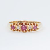 An antique 18ct yellow gold five stone ring set with round cut rubies and small old round cut