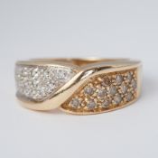 A 9ct yellow gold wide band twist design ring set to one side with approx. 0.13 carats of '