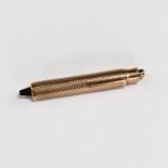 A 9ct gold engine turned engraved watch tool, length approx. 4.7cm, 7.87gm.