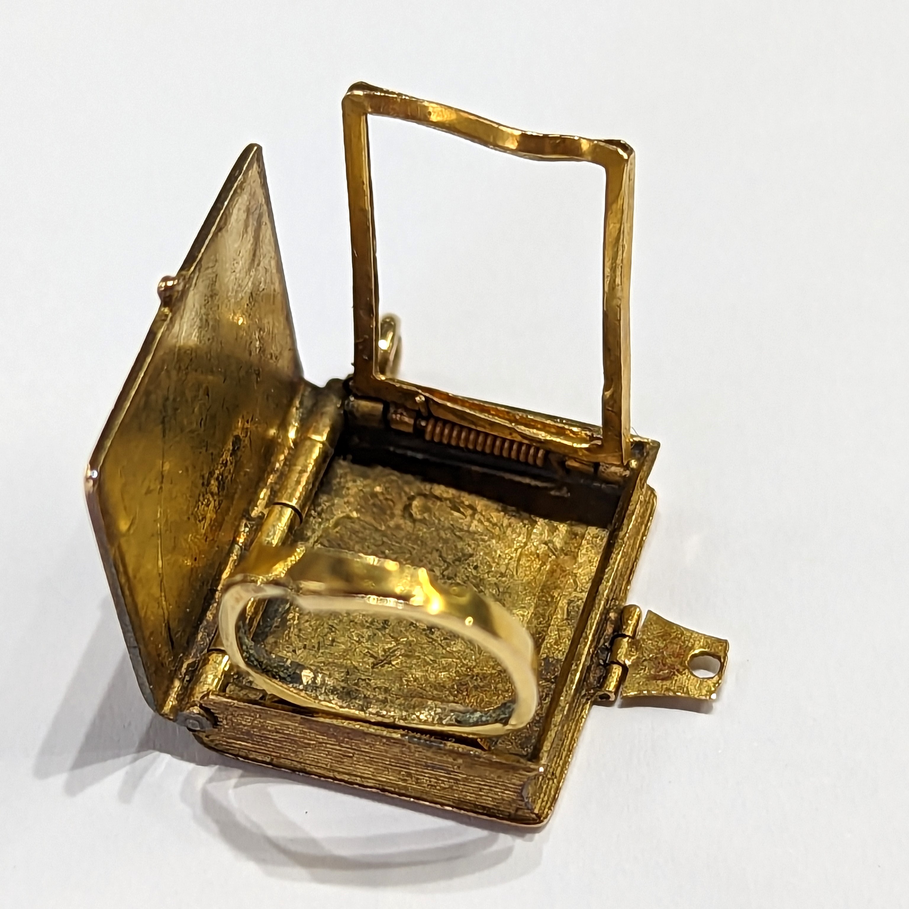 A gold locket in the shape of a book inset with a Dove & envelope set with a small ruby, measuring - Image 4 of 5