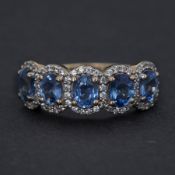 A 9ct yellow gold ring set with five oval cut Ceylon sapphires, total weight 2.32 carats, surrounded