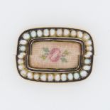 A Georgian yellow gold, black enamel seed pearl & flower tapestry brooch, the tapestry being under a