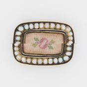 A Georgian yellow gold, black enamel seed pearl & flower tapestry brooch, the tapestry being under a