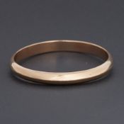 A plain 14k yellow gold hollow D-shaped bangle, circa 1930, diameter 8cm, 32.09gm, engraved