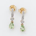 A pair of 9ct yellow & white gold drop earrings set with a pear shaped peridot and small round cut