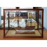 A large scale model boat 'Myrmidon' fitted within a case, overall size including case 67cm x 93cm.