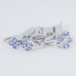 Four silver rings of varying designs set with Tanzanite, total weight with tags 13.34gm, three