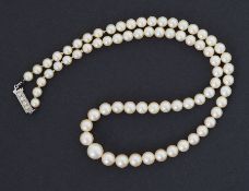 An 18" string of graduated cultured pearls set to a rectangular platinum? clasp set with four