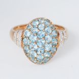 A 9ct yellow gold oval design ring set with round cut blue topaz and two small round cut diamonds