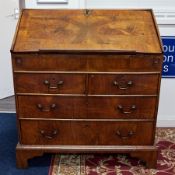 An English 18th Century walnut bureau desk fitted with four drawers on bracket feet height 100cm.