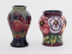 Moorcroft, two small pottery vases, height 10cm and another (2)