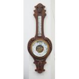 A carved oak Aneroid barometer, approx 90cm.