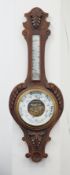 A carved oak Aneroid barometer, approx 90cm.