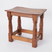 An oak stool, on four octagonal legs joined by stretchers, with carved mouse trademark, height 37cm.