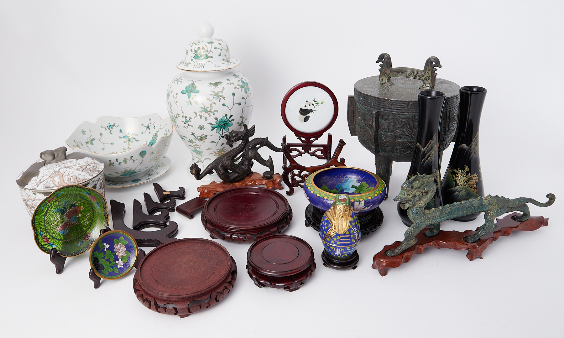 A collection of Oriental replica ornaments including temple jar, dragon figures, metal wares and