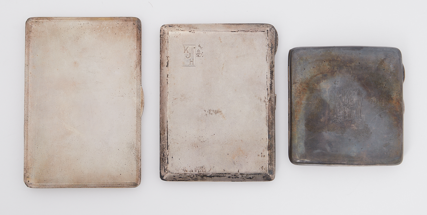 Three silver cigarette cases of varying sizes and designs, total weight 14.51oz.