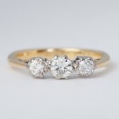 An 18ct yellow gold & platinum three stone ring set with three old round brilliant cut diamonds,