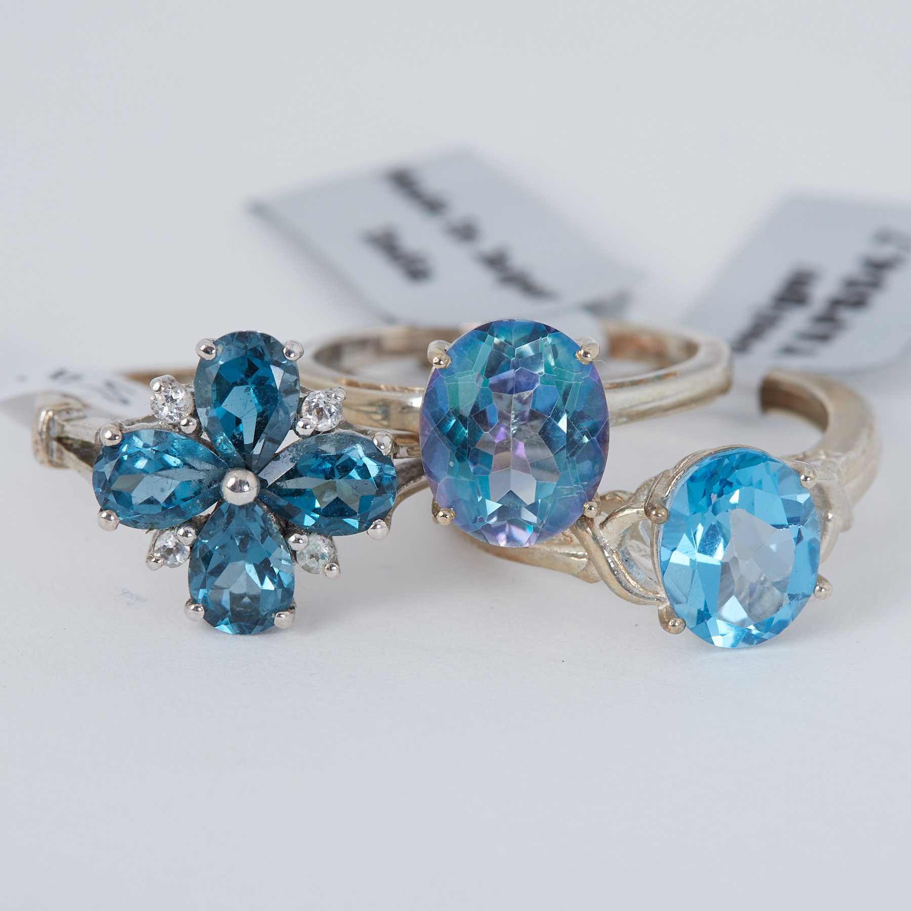 Three silver rings set with topaz to include Swiss blue topaz, London blue topaz & Mystic Neptune