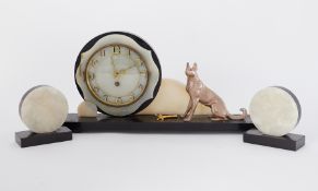 An Art Deco mantle clock and garnitures, with key.