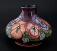 Moorcroft, a squat vase, chipped to base rim, flowers on purple ground, marked 93, height 7cm.