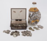 A large collection of English six pence's contained in a Dimple Whisky bottle and also loose coins.