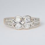 An 18ct yellow & white gold two row twist design ring set with round brilliant cut diamonds, total