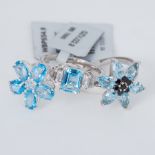 Three silver rings set with topaz to include Spice blue topaz and Swiss blue topaz, total weight