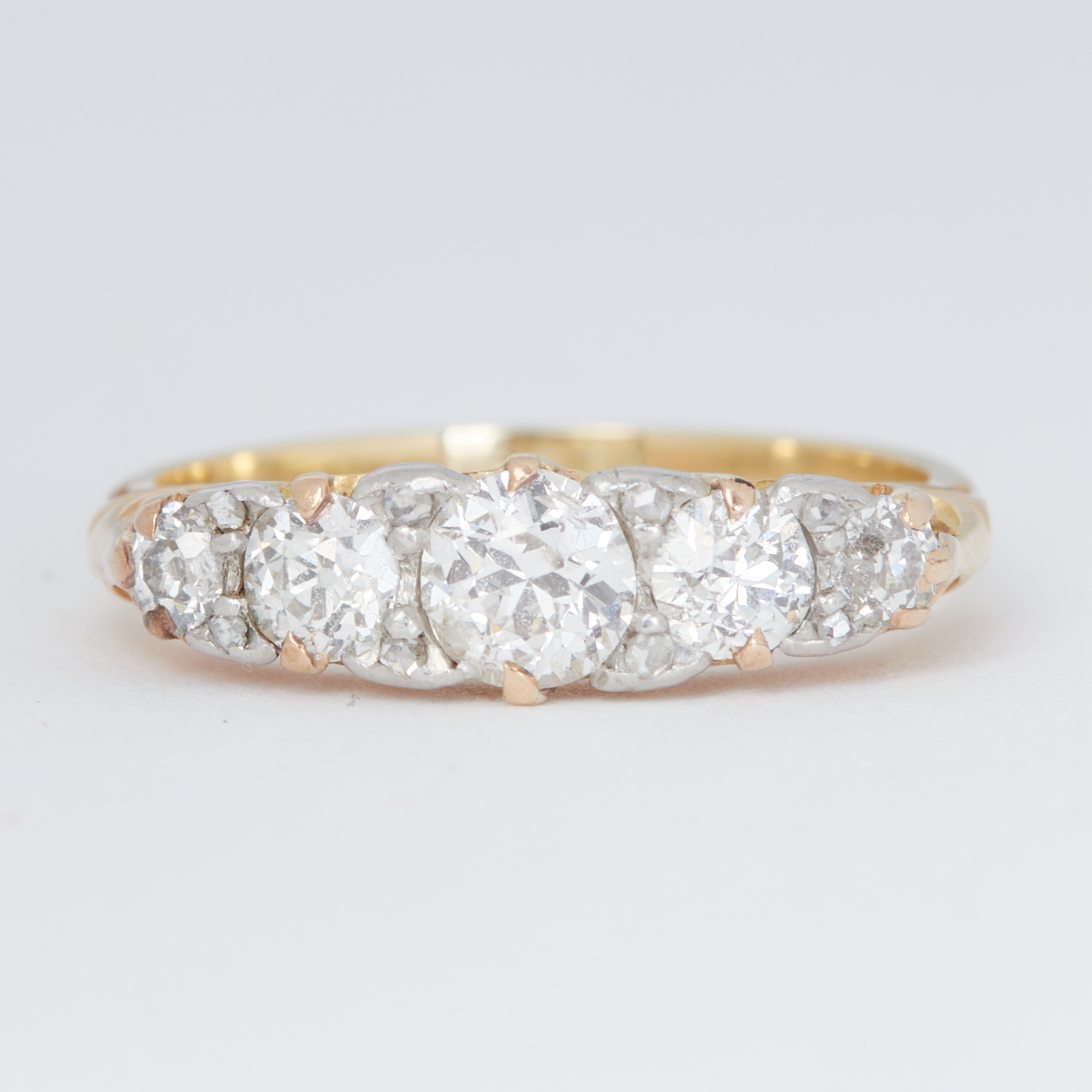 An antique 18ct yellow gold five stone graduated ring set with five old round brilliant cut